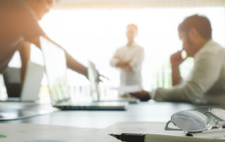 3 people working in a conference room