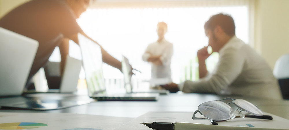 3 people working in a conference room
